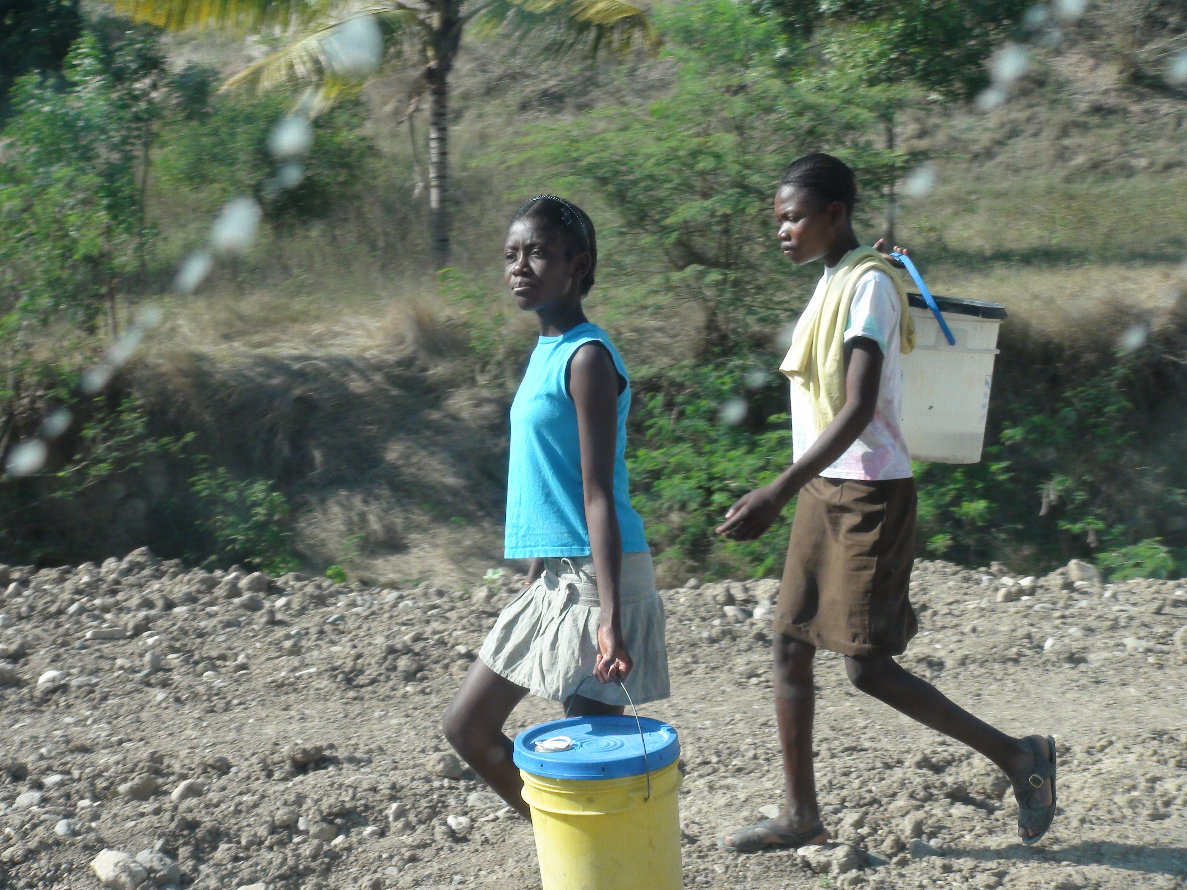 Girls carrying water in Haiti