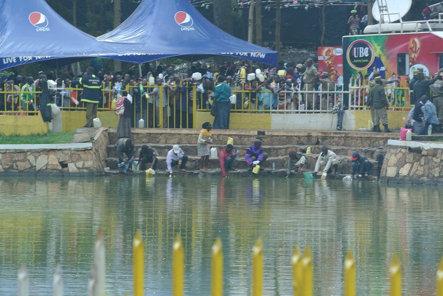 Faithful Catholics drew water from the lake that had been blessed in hopes of bringing healing to their loved ones at home. Faithful Catholics drew water from the lake that had been blessed in hopes of bringing healing to their loved ones at home.