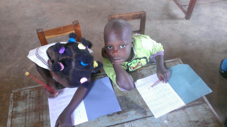 preschoolers sitting at desks