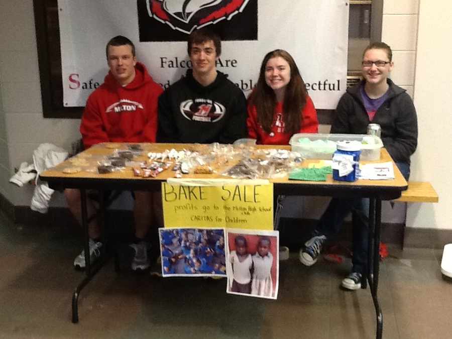 students at table promoting support of charity