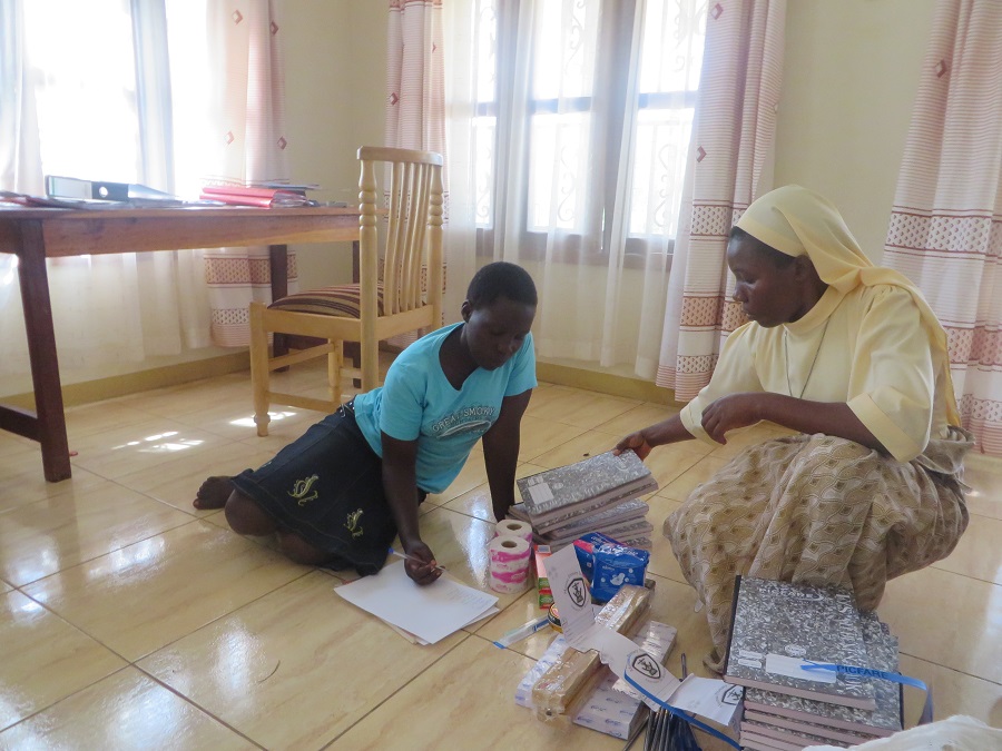 nun and student sorting school supplies