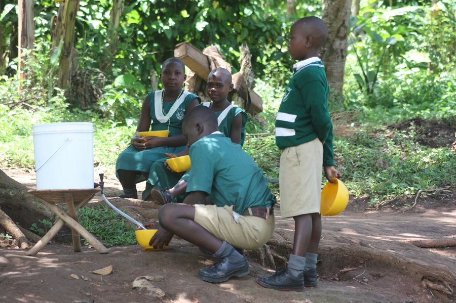 Dispensing clean water after it has been purified through the filter mechanism in the bottom of the bucket