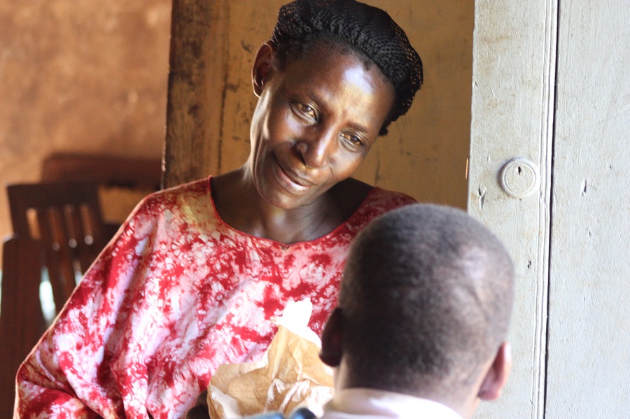 Vanessa gives her Jjajja a hand-made cross made by Terry as a gift to the family
