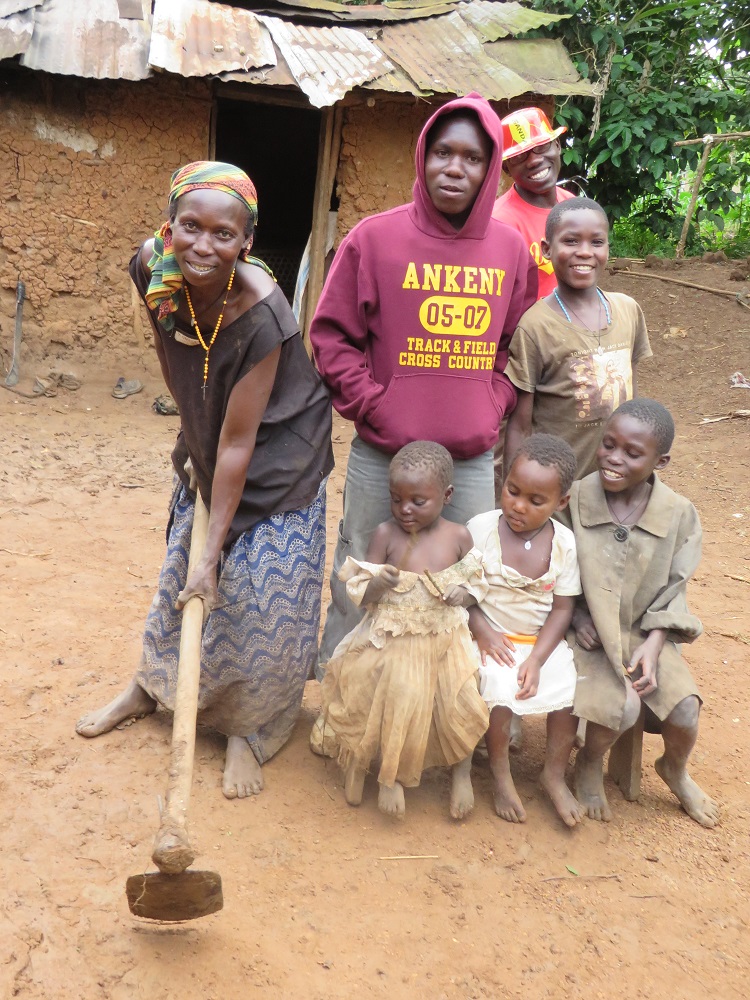 a mother stands with her hoe and her children and grandchildren by her side
