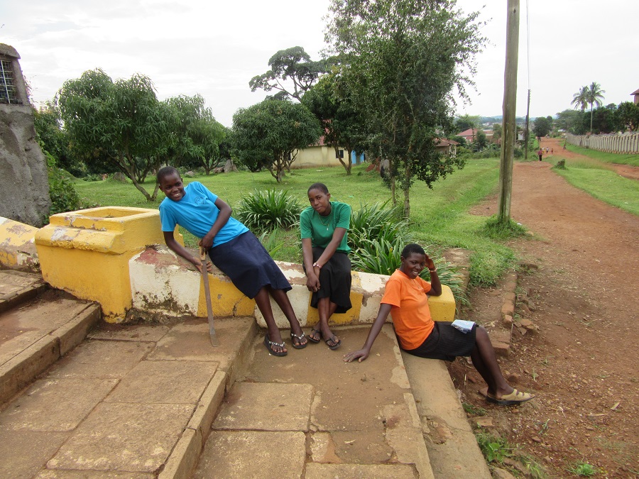 Three teen girls resting on steps.