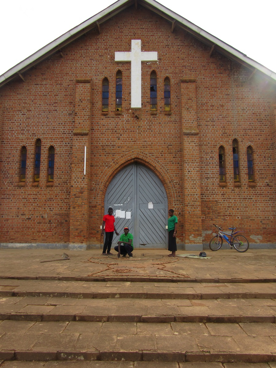 Three teens by church entrance.