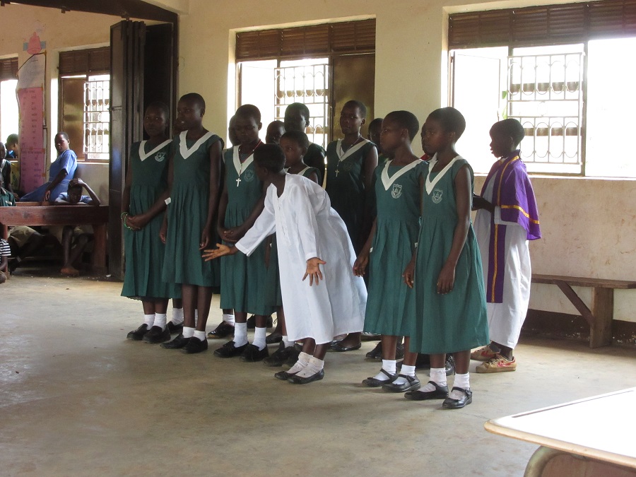 Students from St. Alphonsus Demonstration School present a song and skit about the Catholic Church.