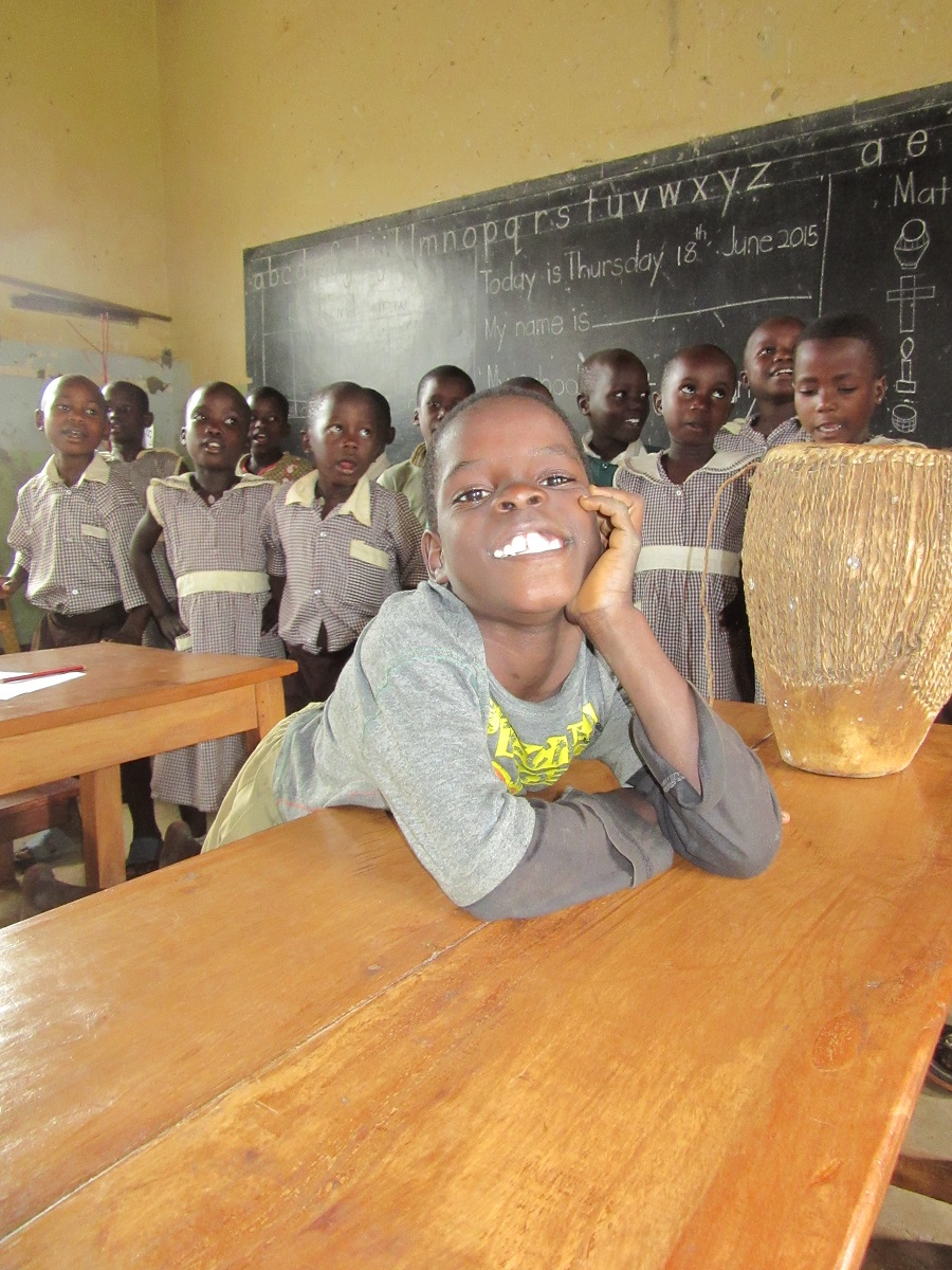 Solomon smiles from his desk in Top Class, the most advanced class at St. Anthony Nursery School.