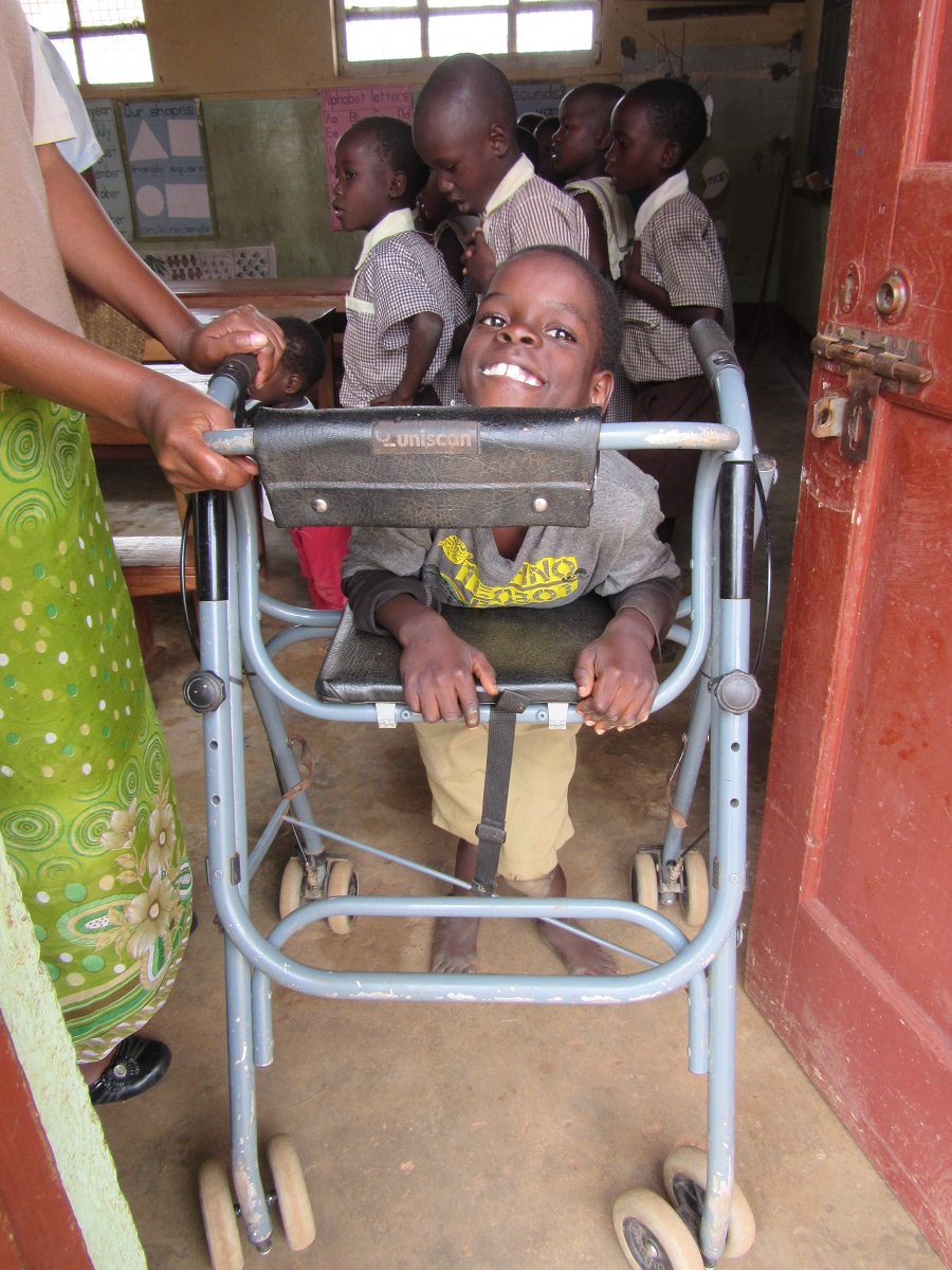 Solomon uses his walker, acquired at Providence Home, to get around in the classroom.Trips outside of the classroom, however, such as walking to the bathroom or the playground, remain a struggle. 