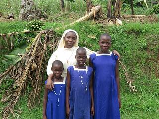 Sister Carolyne stands with Tobit Babirye, Oliver Nakitanda, and Jovia Nabakawa (from left to right), who are sisters, despite having different names. What appear to be surnames, to those unfamiliar with Ugandan naming convention, are individual clan names that are used by their specific clan. Ugandans are readily able to identify them as coming from a specific clan based on their individual clan names. As indicated by her name, Babirye has a twin, David, who was born just after she was. Sister Carolyne stands with Tobit Babirye, Oliver Nakitanda, and Jovia Nabakawa (from left to right), who are sisters, despite having different names. What appear to be surnames, to those unfamiliar with Ugandan naming convention, are individual clan names that are used by their specific clan. Ugandans are readily able to identify them as coming from a specific clan based on their individual clan names. As indicated by her name, Babirye has a twin, David, who was born just after she was.