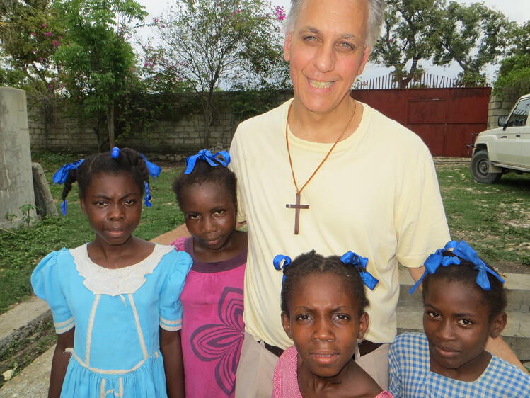 Fr. LoBianco with children from CARITAS child sponsorship programs