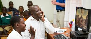 Joseph with Child Skyping with Sponsor Photo